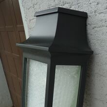 Roger Pradiers Wandlampe Louis Philippe Nr. 7 in der Farbe Schwarz vereint klassisches Design und moderne Materialien. Diese flache, viereckige Wandleuchte passt ideal zu klassischen und modernen Fassaden und kann rechts und links einer Haustür montiert werden.